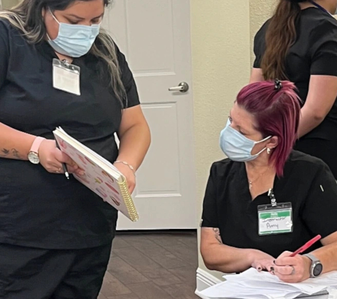 instructor reviewing a diagram with a medical assistant student