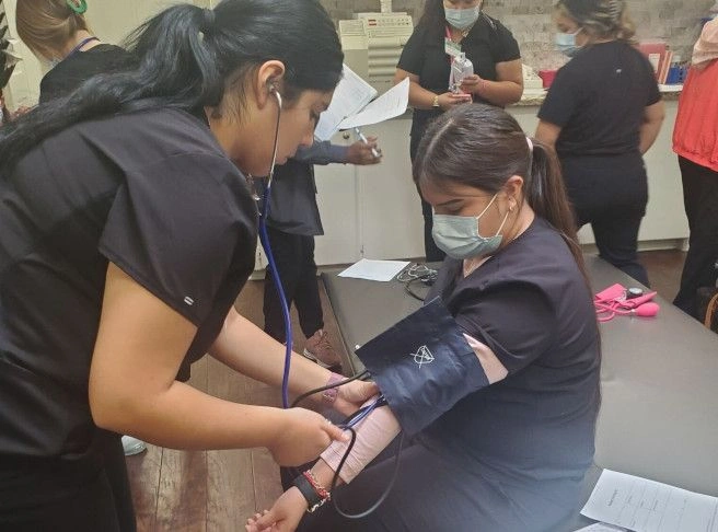 students training to take blood pressure from patients